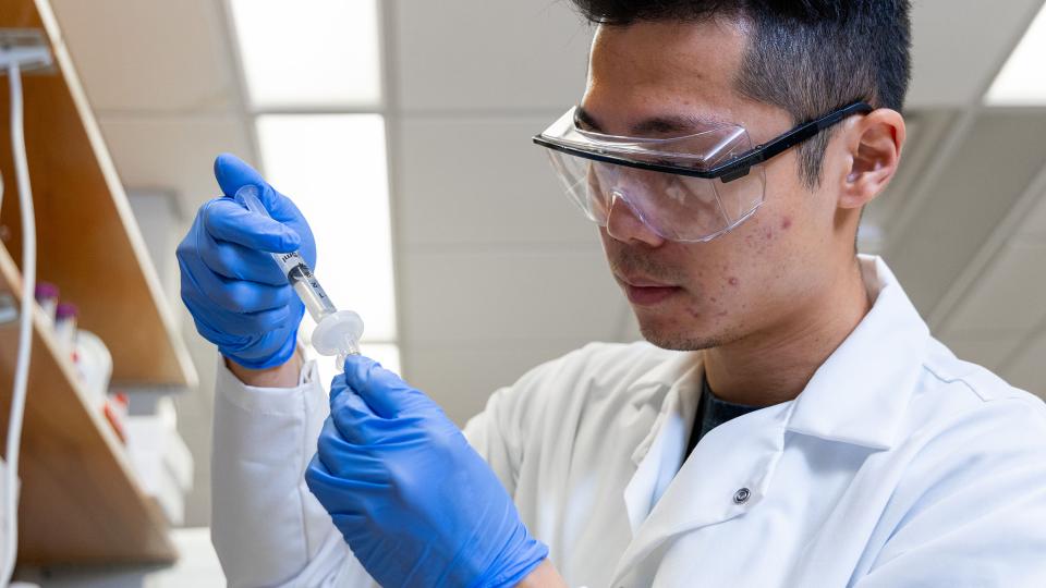 Student in the lab working with a sample